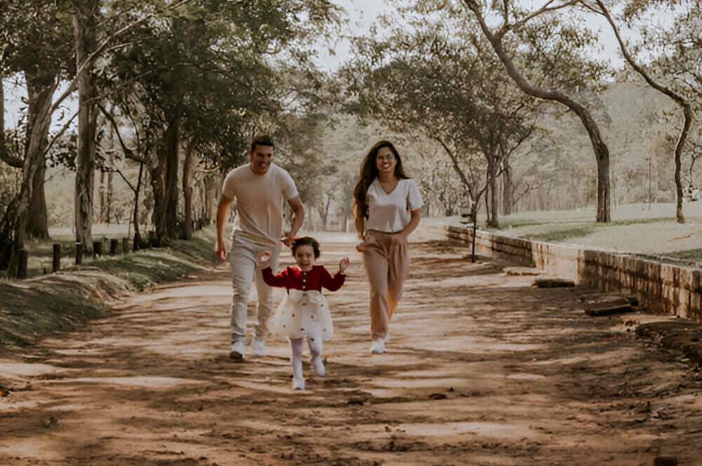 thrill-seeking dads illustrated by a father and mother running down a path with their daughter