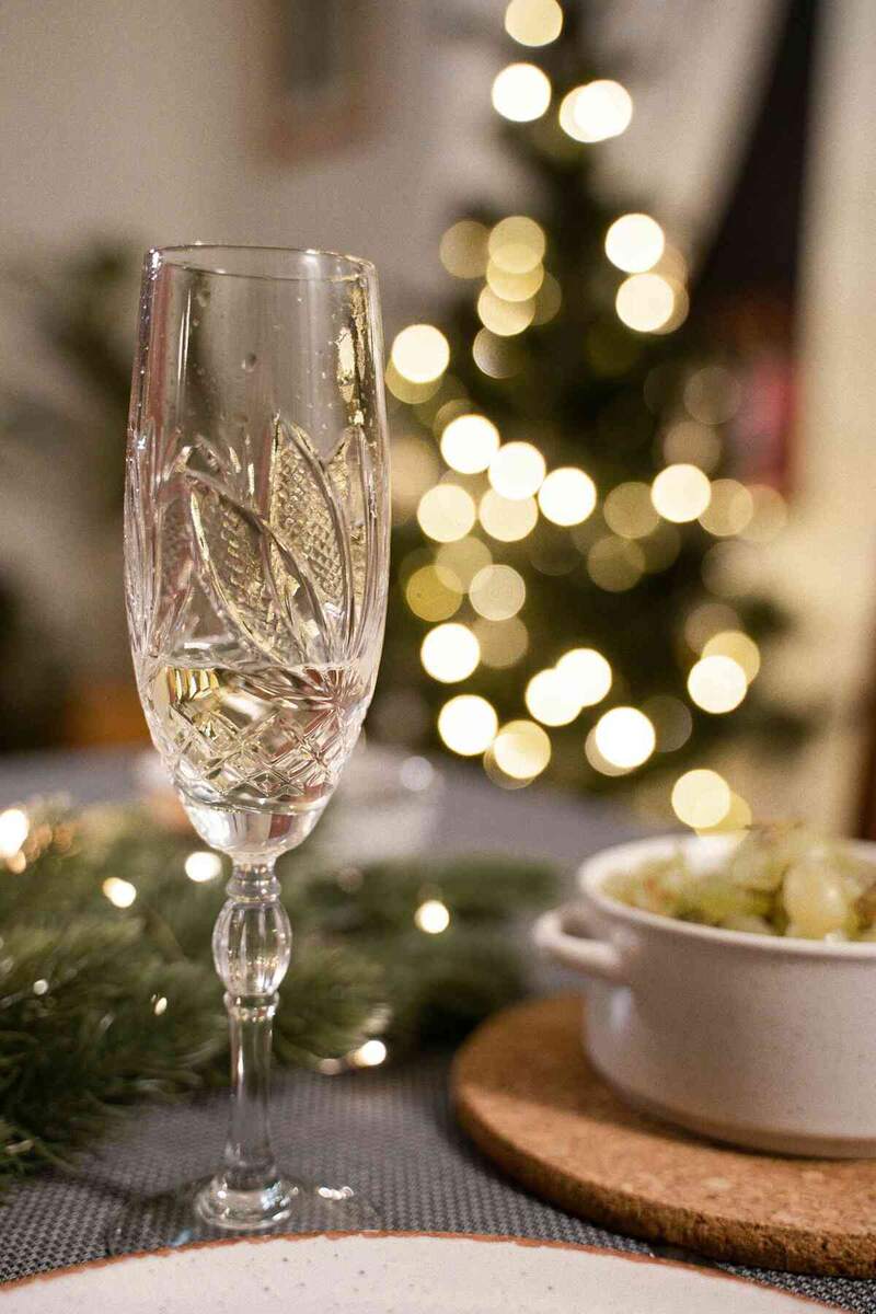 champagne flute in front of christmas tree to illustrate Christmas in the Elgin Valley